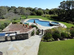 Second story view of a new outdoor living area. Both patio and kitchen area were done in irregular blue stone. 